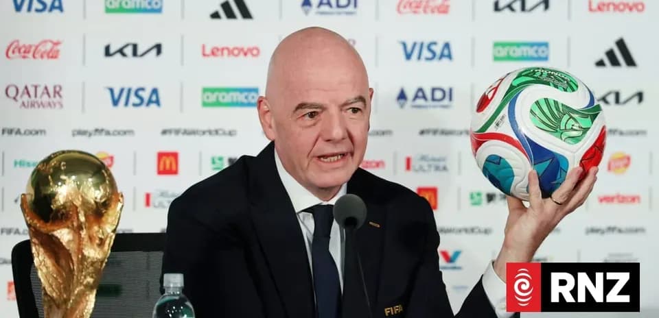 FIFA president holding World Cup trophy and ball