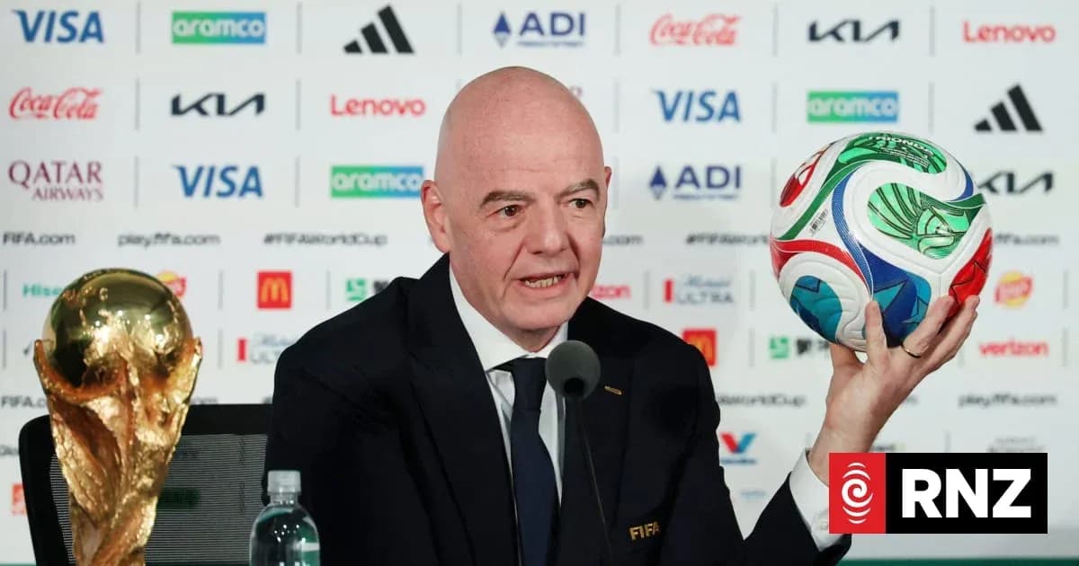 FIFA president holding World Cup trophy and ball