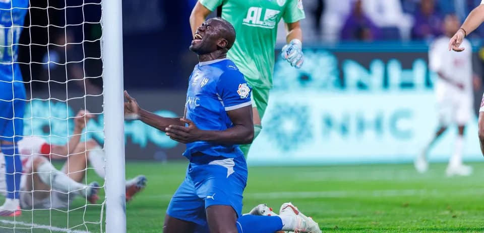 Player kneeling near goal post after missed chance