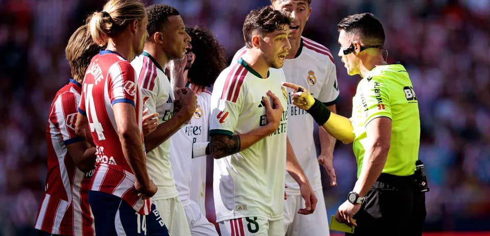 Real Madrid players arguing with the referee during match