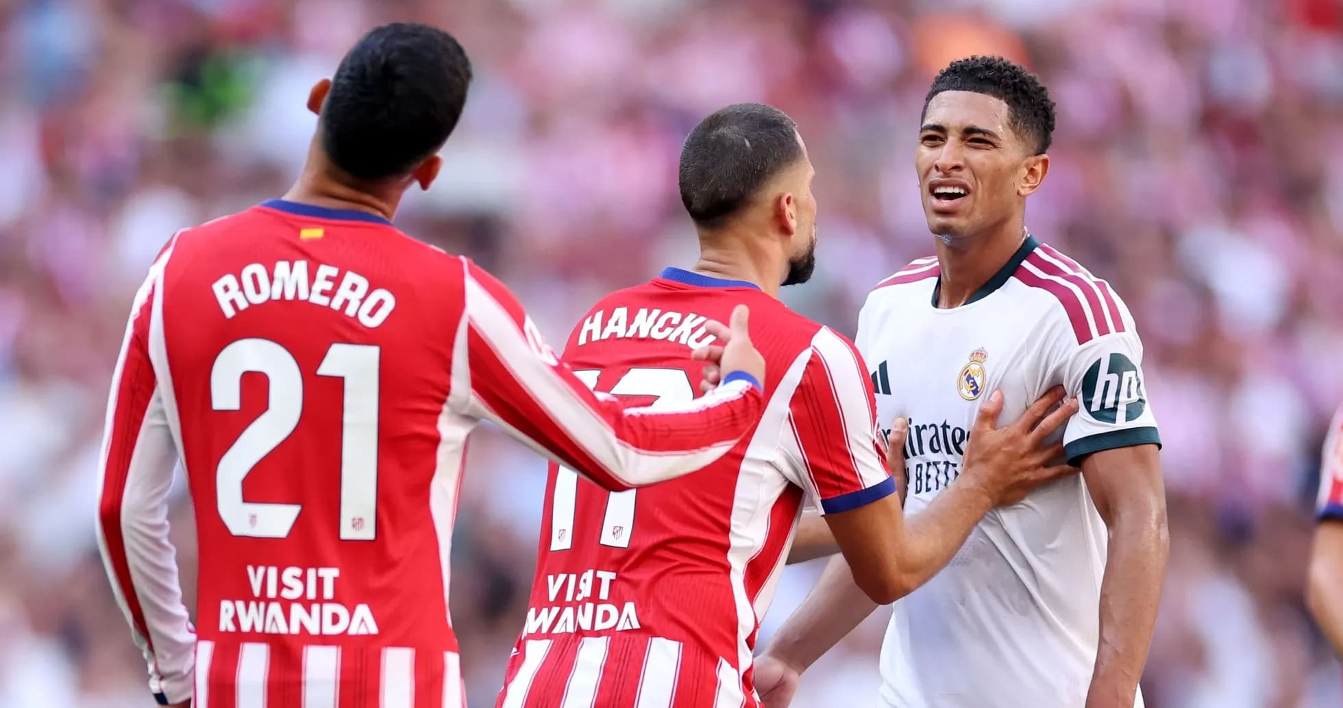 Atletico Madrid players confront Real Madrid player