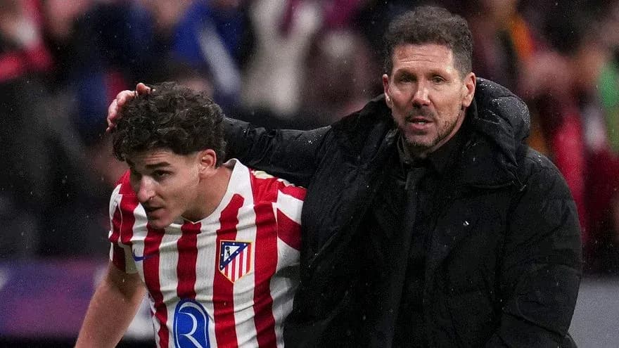 Atletico Madrid player assisted by coach during match