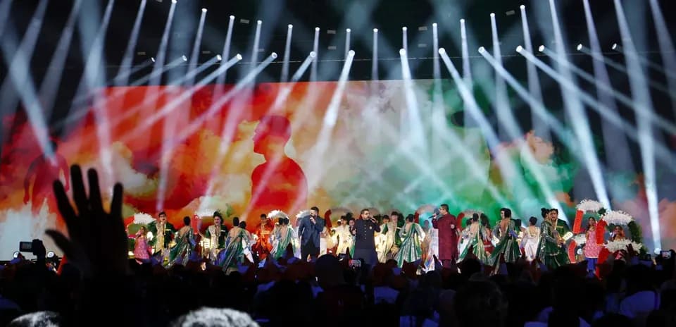 Cultural performance on stage with colorful lights