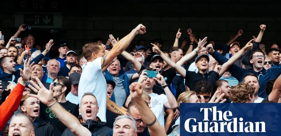 Football fans cheering passionately in the stands