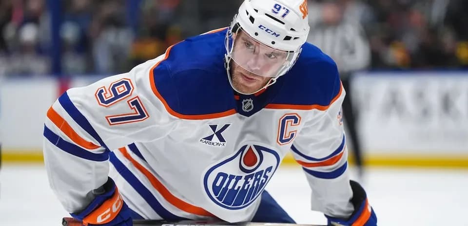 Hockey player wearing Edmonton Oilers jersey on ice
