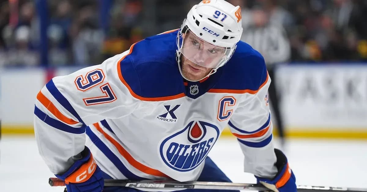 Hockey player wearing Edmonton Oilers jersey on ice