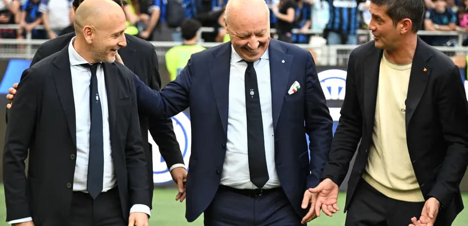 Coaches interacting on the field before match