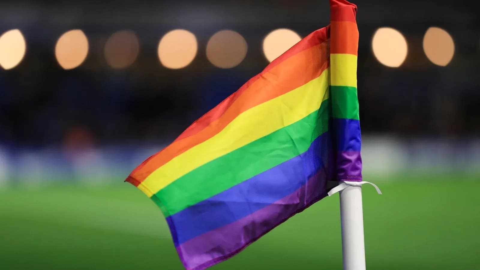 Rainbow flag on corner flag at football match