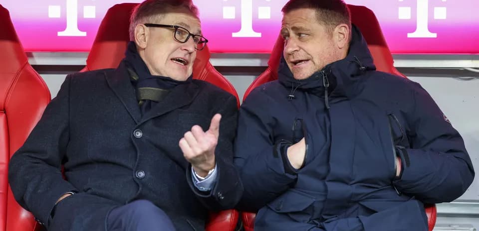 Two officials seated on the bench discussing