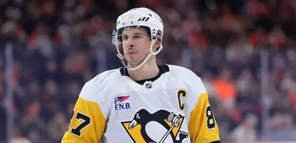 Hockey player wearing Penguins jersey on ice rink