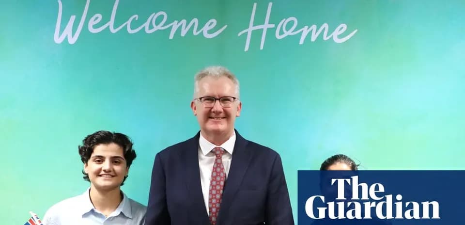 Three individuals posing in front of 'Welcome Home' sign