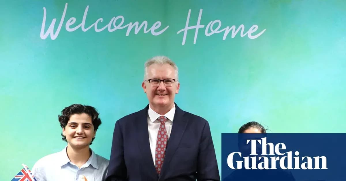 Three individuals posing in front of 'Welcome Home' sign