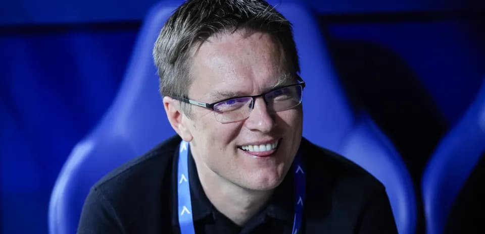 Smiling man seated in a sports venue