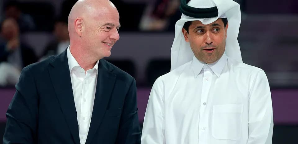 Two officials speaking at an event in Qatar