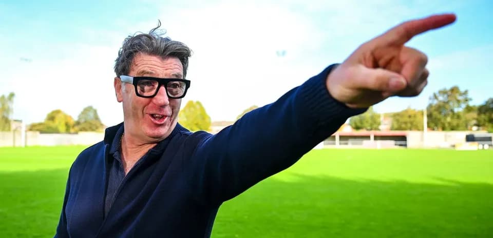 Man pointing on a football field background
