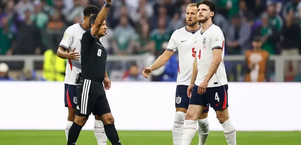 Referee showing yellow card to England player