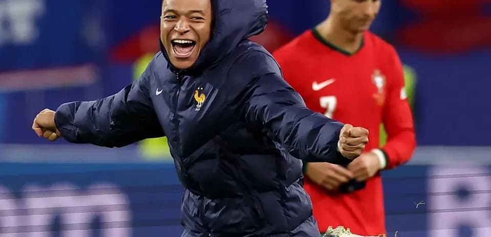 Mbappe celebrating on field with Ronaldo in background