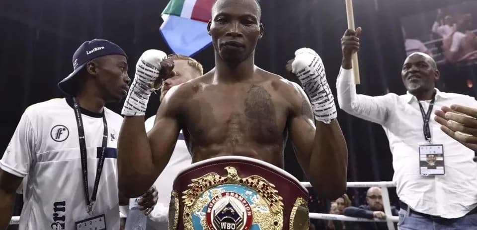 Boxer celebrating with championship belt after victory