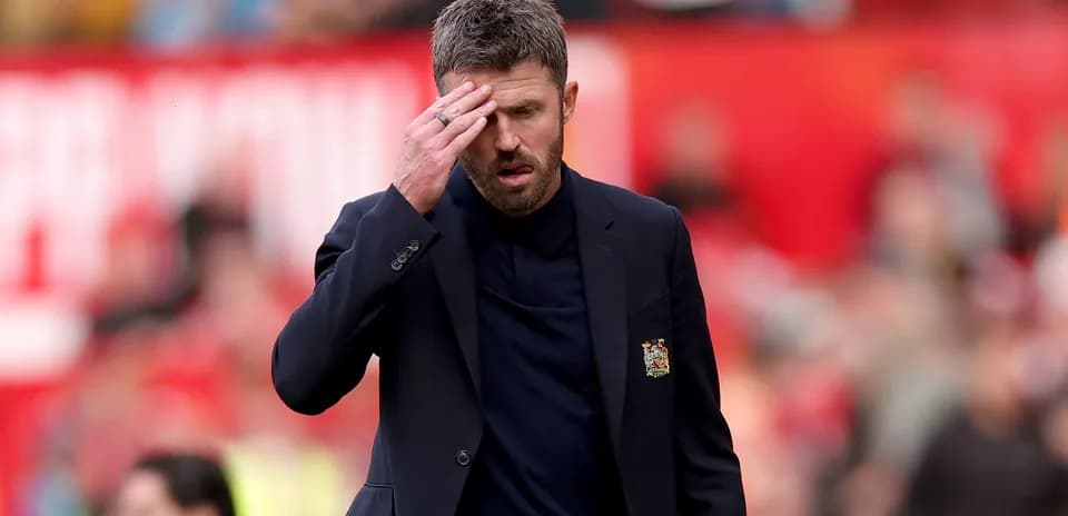 Men's football coach walking on the pitch