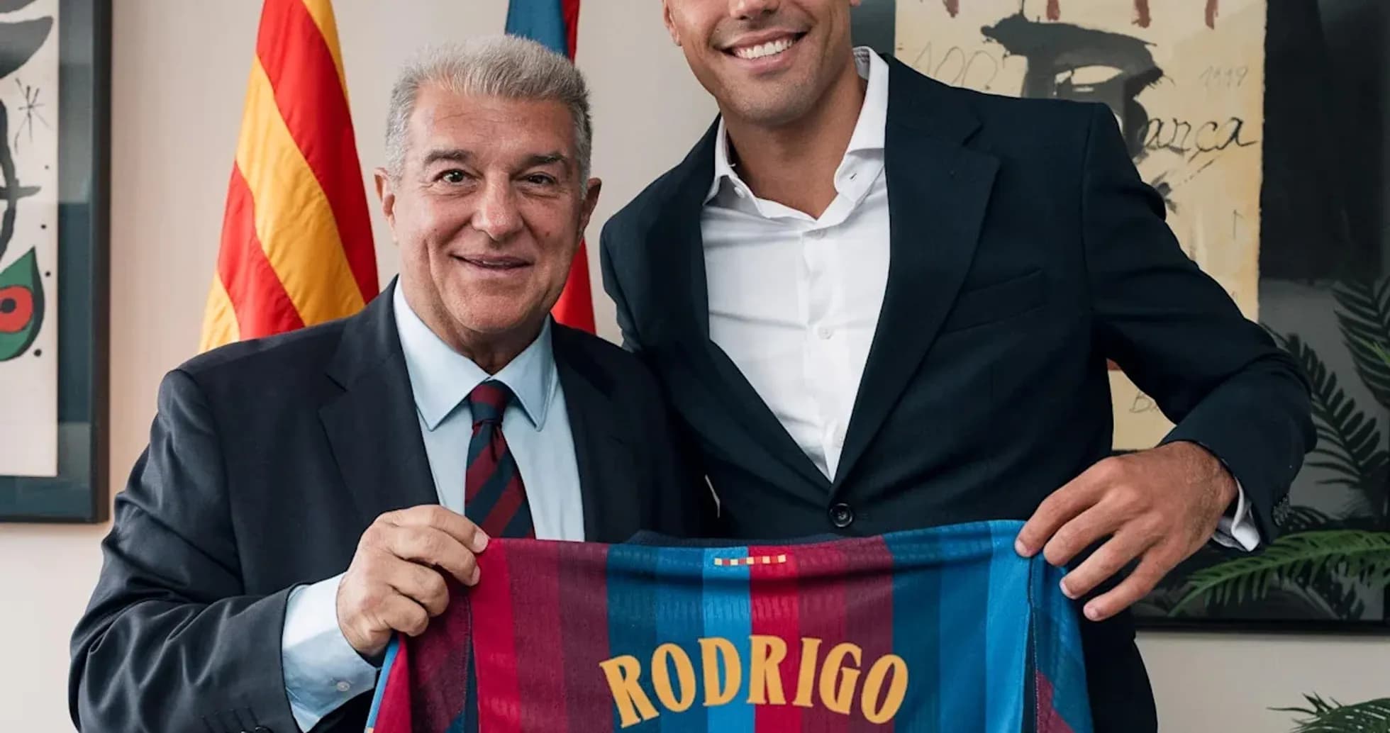 Rodrigo holding Barcelona jersey with club president