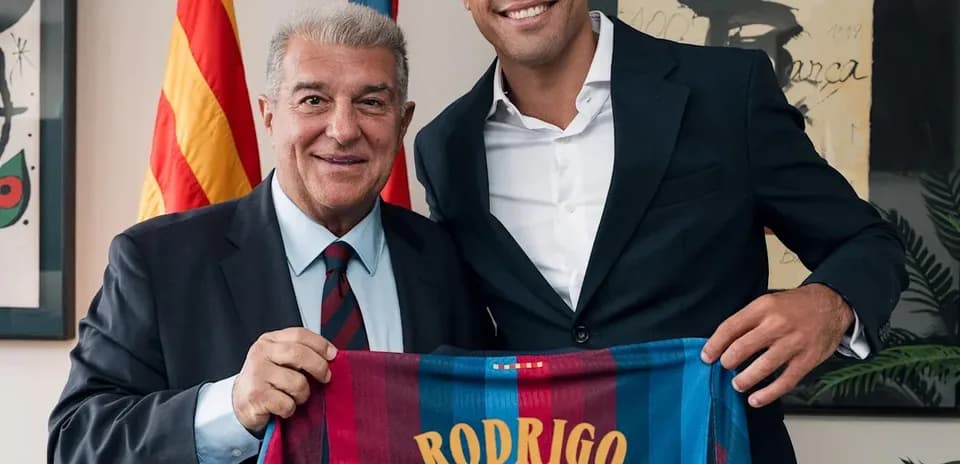 Rodrigo holding Barcelona jersey with club president