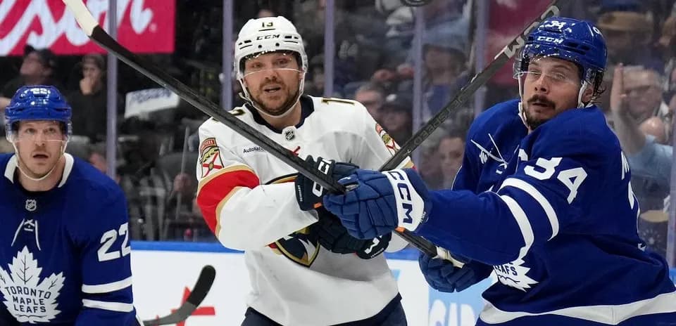 Players battling for puck during NHL game action