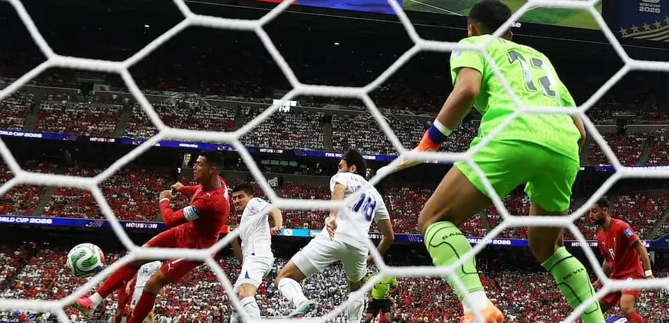 Goalkeeper preparing to block shot during match