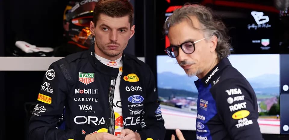 F1 driver and engineer discussing in garage