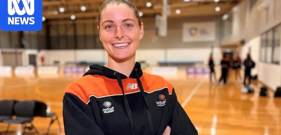Netball player smiling in training venue