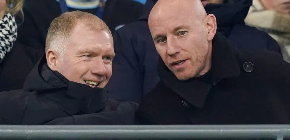 Two men conversing in stadium seats during event