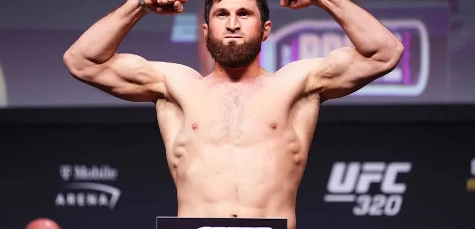 Fighter flexing muscles during weigh-in event
