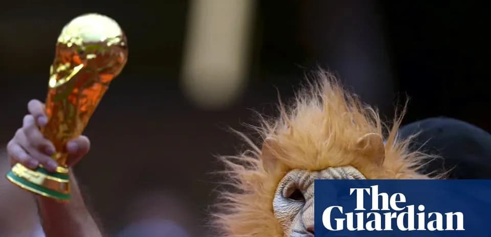 Fan in lion mask holding World Cup trophy