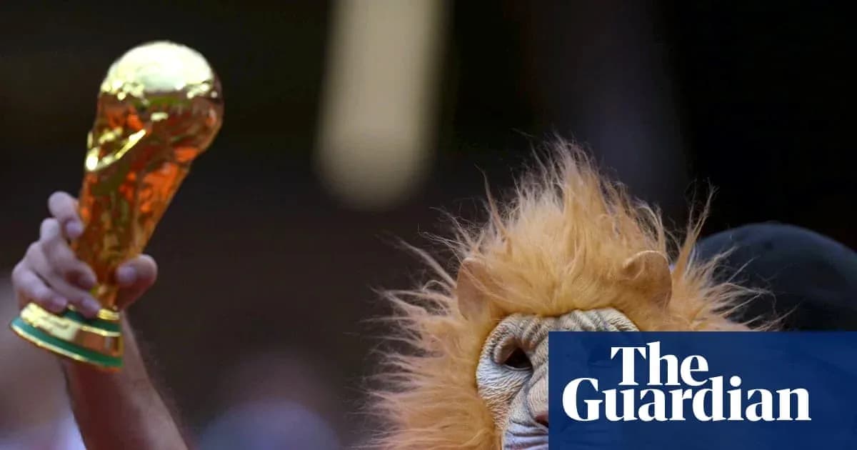 Fan in lion mask holding World Cup trophy