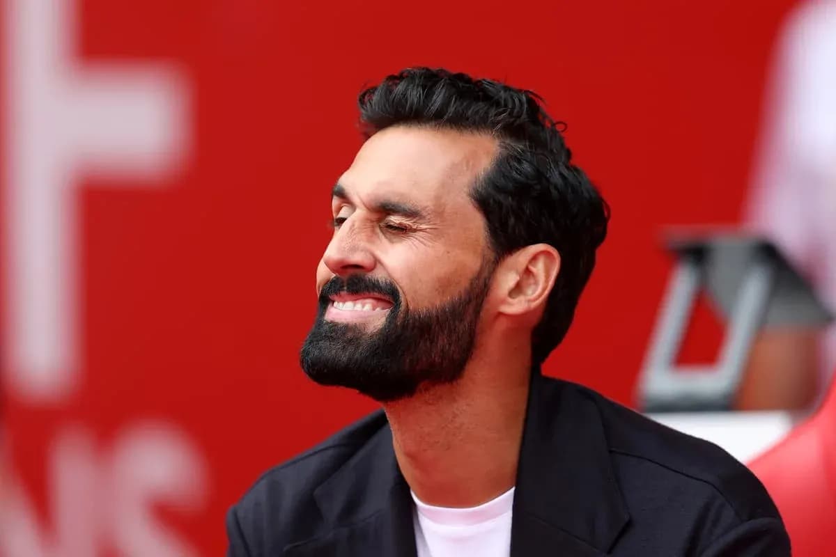 Man smiling while sitting on bench with red background