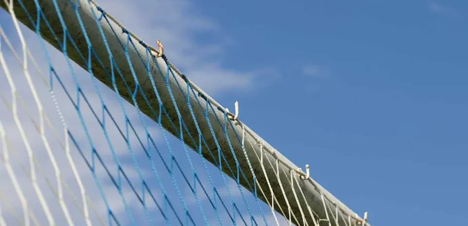 Goal net against a blue sky background