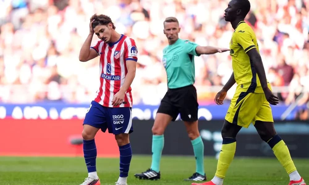 Atlético Madrid player reacts during match with referee