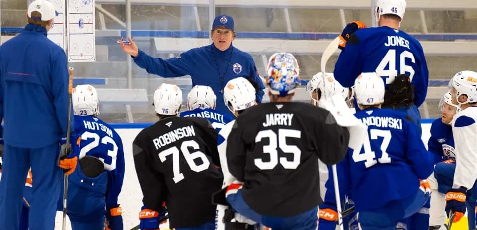 Coach instructing players during a hockey training session
