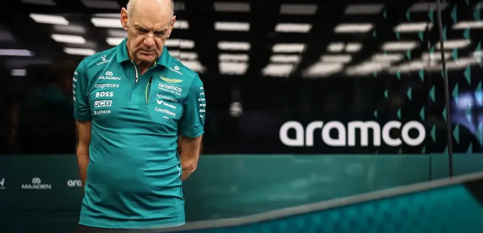 Team member in Aston Martin uniform observing data