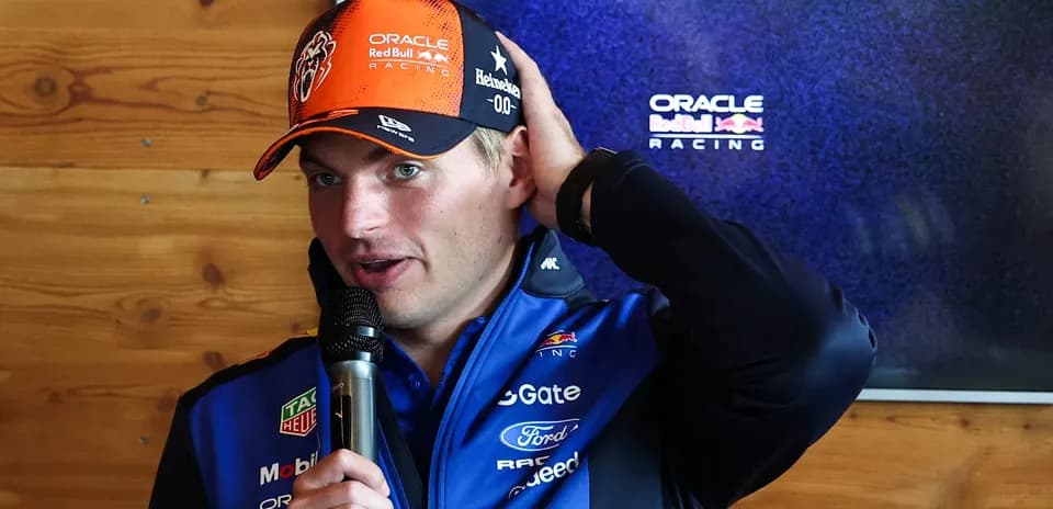 Max Verstappen speaking at press conference with microphone