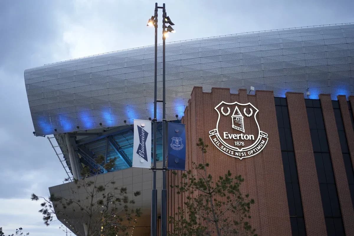 Everton stadium exterior with club logo illuminated