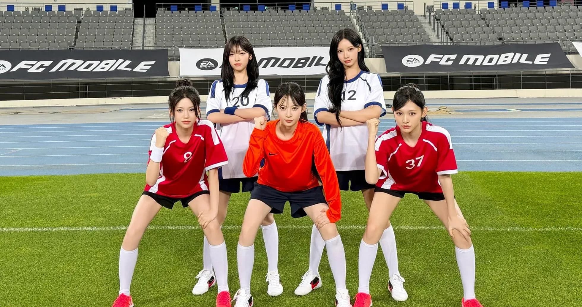 Five female players posing in football uniforms
