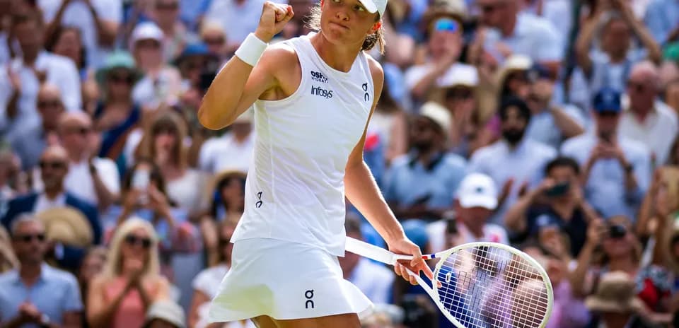 Tennis player celebrating in front of crowd