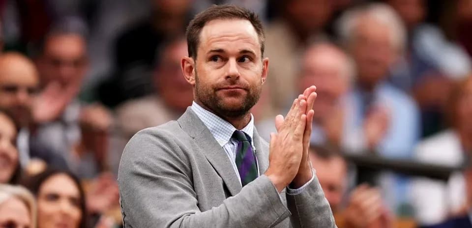 Man in gray suit applauding in audience