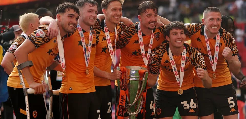 Hull City players celebrating with trophy after victory