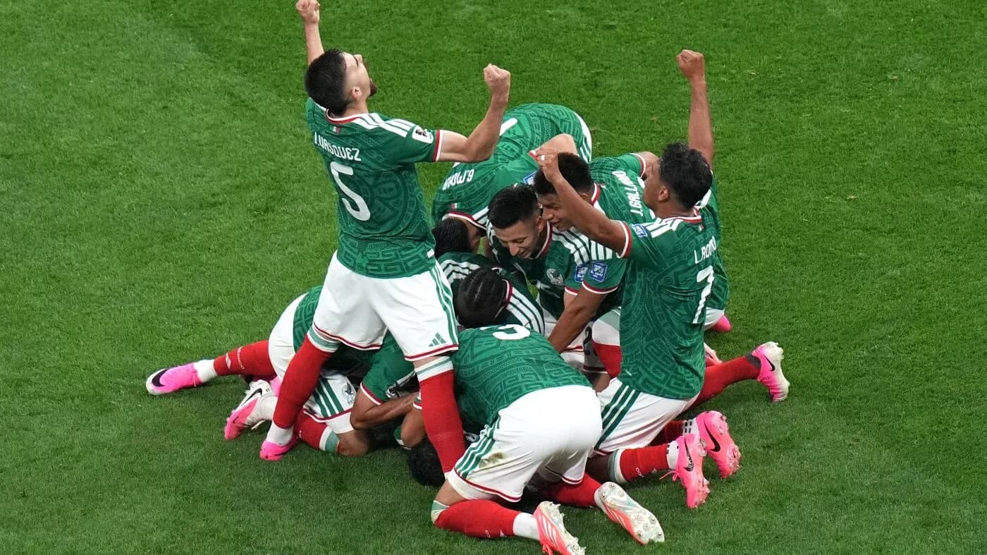 Mexican players celebrating a goal on the field