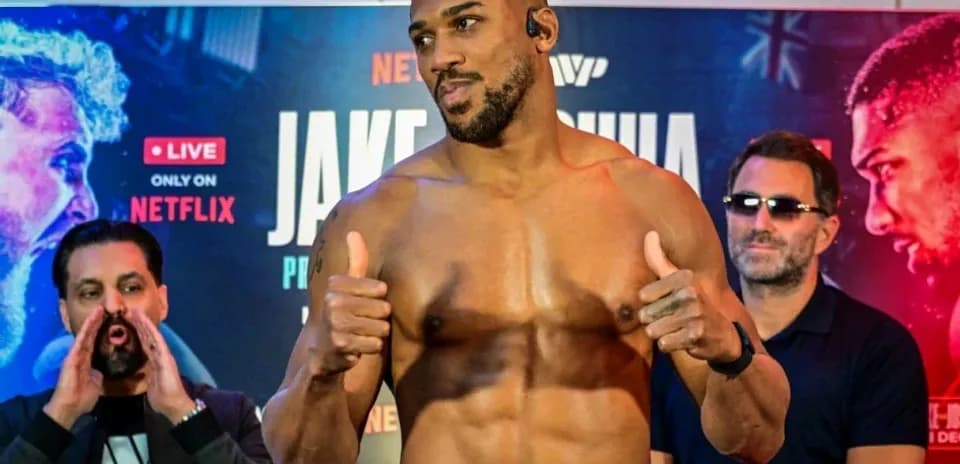Boxer posing at weigh-in event with supporters
