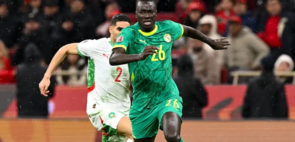 Senegal player running with ball during match