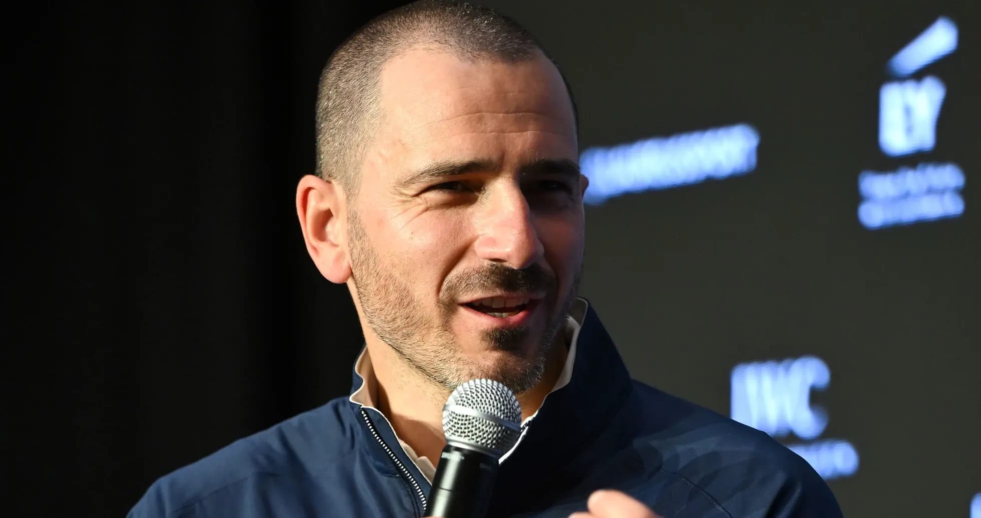 Speaker holding microphone at event presentation