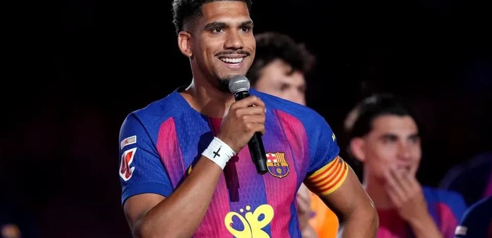 Futbolchi mikrofon bilan sahnada nutq soylamoqda