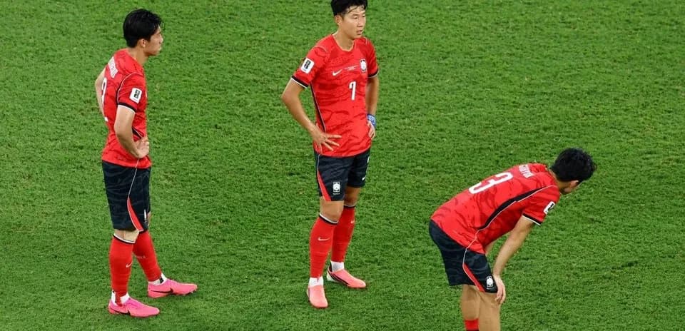Three South Korean players on the field after match